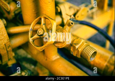 Old abandoned industrial engine that was used in mining industry in the past. Detail of valve and pipeline Stock Photo