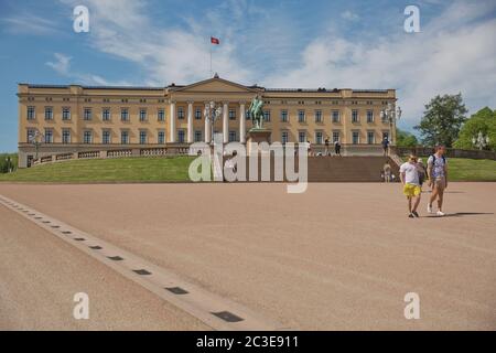 People visiting and enjoying the Royal Palace and statue of King Karl Johan XIV in Oslo, Norway Stock Photo