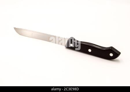 Chromium sawtooth knife with a black handle on a white background Stock Photo