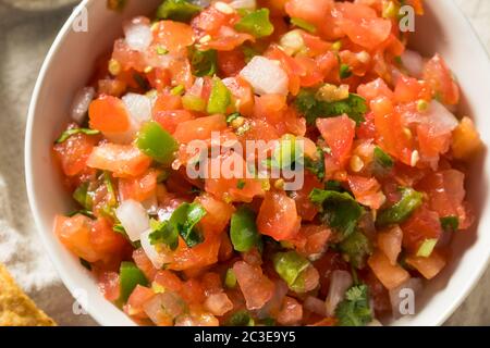 Spicy Homemade Pico De Gallo with Cilantro and Chips Stock Photo