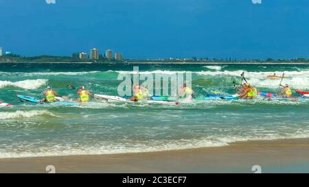 ALEXANDRA HEADLAND, QUEENSLAND, AUSTRALIA- APRIL 24: surf ski race competitors leaving the beach in a race Stock Photo