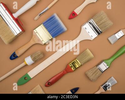 Building tool. Paint brushes. Beige background. The view from the top. The concept of repair. Stock Photo