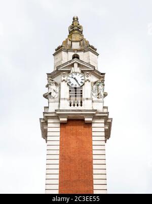 Clock Tower with Statues and Roman Numerals Stock Photo