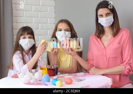 quarantined family paints eggs for easter Stock Photo
