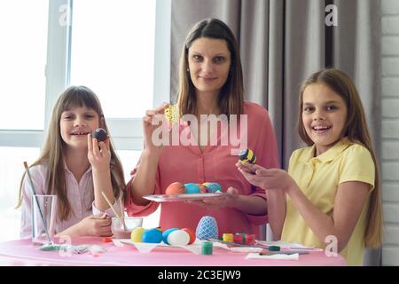 Mom and children show what beautiful Easter eggs they got Stock Photo