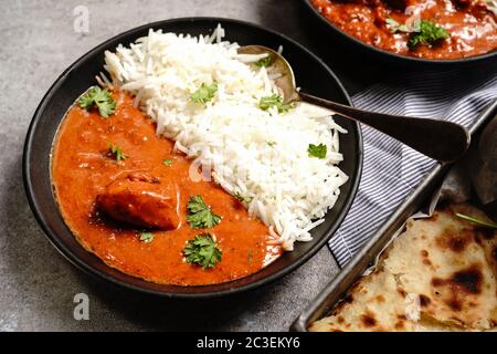 Creamy Butter Chicken/Murgh Makhani served with Roti and Basmati rice Stock Photo