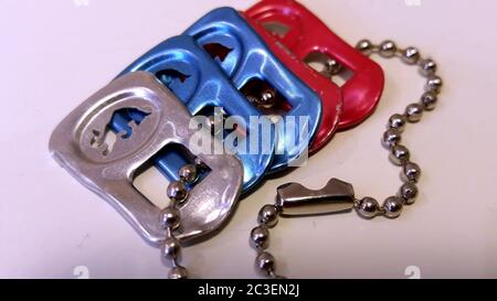 Moscow. February 2019. Colorful Red Bull can pull tabs on a chain. Stock Photo