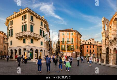 Verona / Italy - May 24 2018: View of Piazza Bra with tourists and shops. The Roman Arena is on the right. Stock Photo