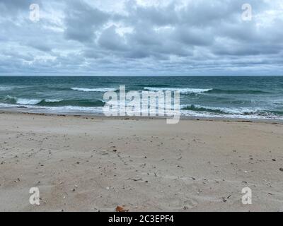 Ocean waves lapping on the beach  on a beautiful sunny day along the shoreline on North Hutchinson Island Florida. Stock Photo