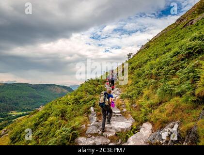 Ben Nevis / UK - August 24 2019: People hike on 'Mountain Path', the most popular route up Ben Nevis, in Scotland. Stock Photo