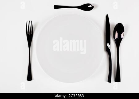 White ceramic round plate isolated on white. Start food concept. Stock Photo