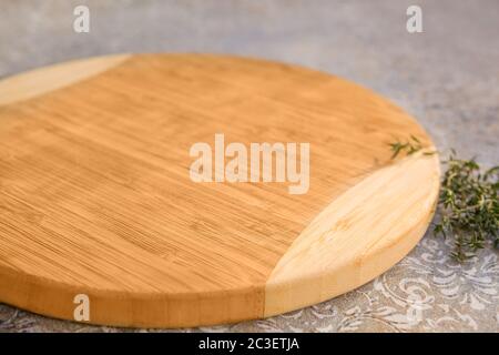 Vintage wooden chopping board on table. Stock Photo