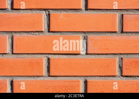A close up of a brick building. background section of brick wall orange close-up, part of brick wall. Stock Photo
