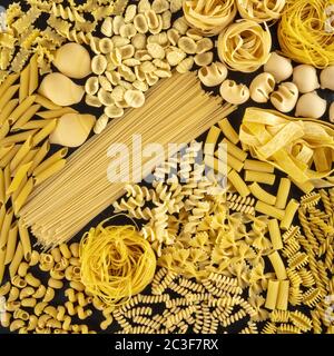Italian pasta square background texture, a flat lay of many different pasta types, shot from the top on a black background Stock Photo