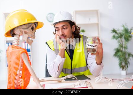Funny construction business meeting with boss and skeletons Stock Photo