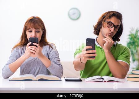 Two students in gadget dependency concept Stock Photo