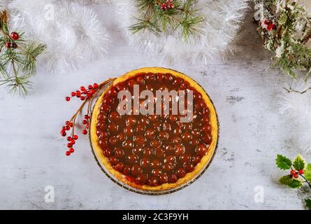 Cherry cheesecake with berry jelly on the top with cake shovel. Christmas decotation. Stock Photo