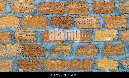 Brick wall of yellow shell rock. Closeup of shellstone texture. Background. Wide photo Stock Photo