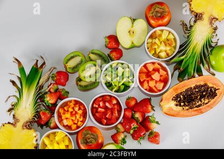 Tropical colorful whole and cut fruits on white background. Stock Photo