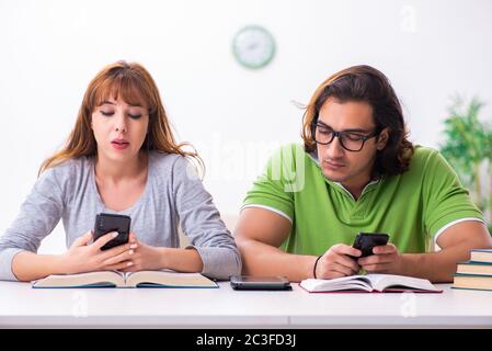 Two students in gadget dependency concept Stock Photo