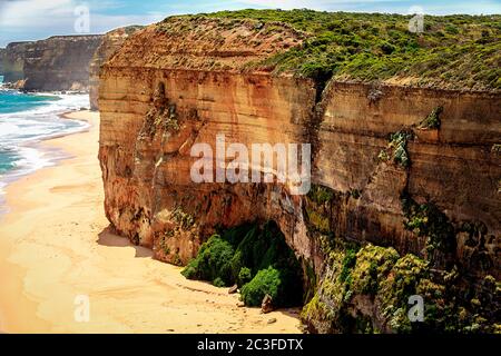 Red coloured cliffs along the Victorian coastline of Australia at the site of the Twelve Apostles. Stock Photo