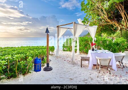 Table set up for romantic dinner on beach at Seychelles Stock Photo