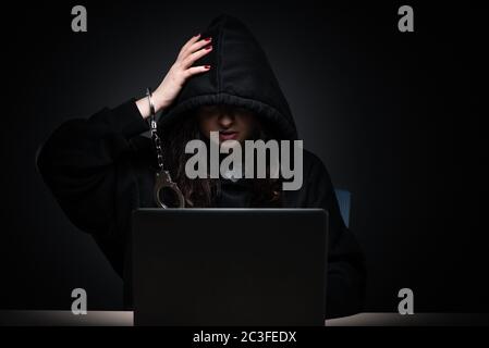 Female hacker hacking security firewall late in office Stock Photo