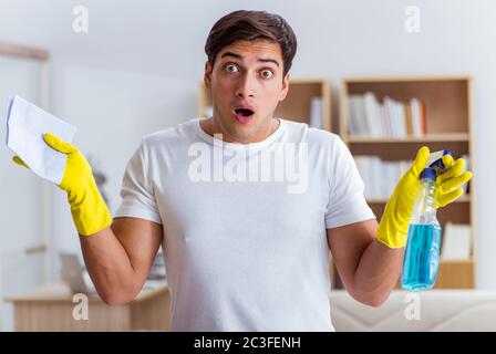Man husband cleaning the house helping wife Stock Photo