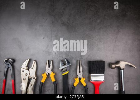Home Repair Hand Tools on a cement gray background. Concept home repair, Home improvement, Renovate home.Construction Tools Concept Stock Photo