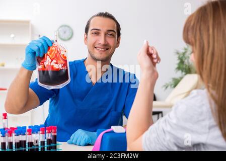 Young woman in blood transfusion concept Stock Photo