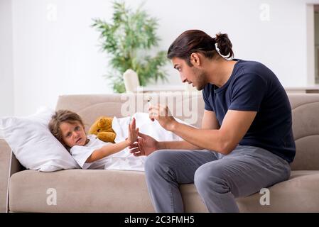 Father taking care of his ill daughter Stock Photo