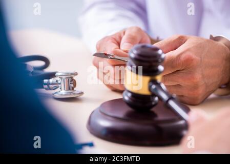 Male doctor in courthouse meeting with lawyer Stock Photo