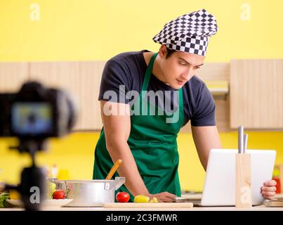 Young chef blogger explaining food preparation Stock Photo