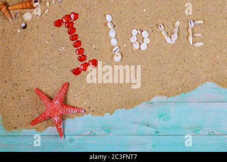 Word love made from sea shells on sand. Travel or Valentines day concept. Stock Photo