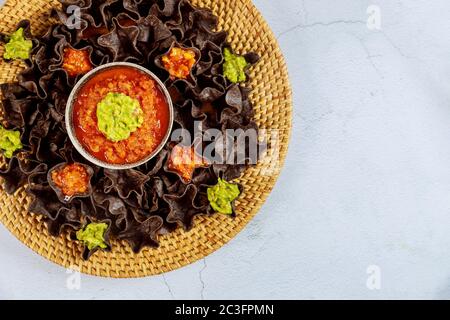 Blue corn tortilla chips with salsa and guacamole. Close up. Mexican food. Stock Photo