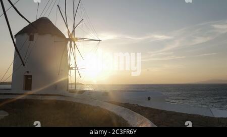 sunset shot of the windmills on mykonos greece with lens flare Stock Photo