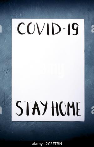 Covid-19 design template with the Stay at home message in handwriting and place for data Stock Photo