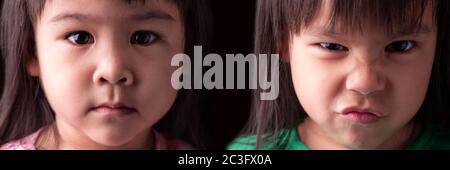 Portrait half face of Asian sibling child girls with sad and angry expression on dark background. Stock Photo