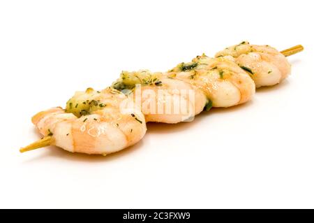 BBQ shrimp - Shrimp skewers ready to grill on a white plate / bottom. Stock Photo