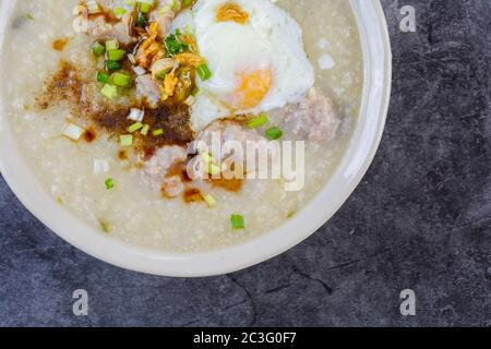 Congee, Rice porridge with minced pork, boiled egg, great for breakfast. Stock Photo