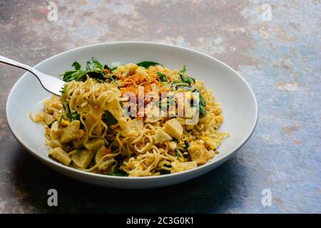 Fried noodles with Vietnamese Grilled Pork Sausage, eggs and Gnetum gnemon leaves Stock Photo