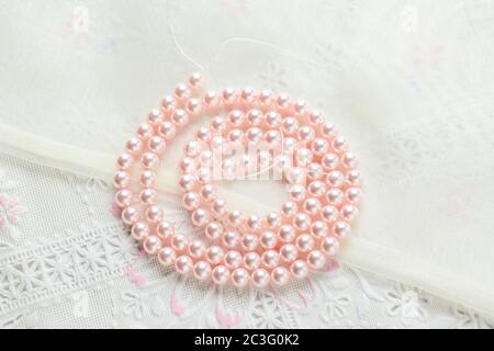 pearl necklace on white fabric background, Close up shot of glass pearls Stock Photo