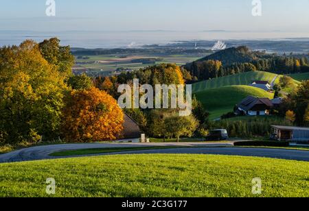 Peaceful autumn sunny morning rural view from Gmundnerberg with misty countryside in far, Austria. Stock Photo