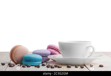 Macaroons with coffee on wooden table Stock Photo