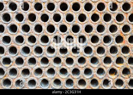Tube sheet or plate of heat with welded tubes texture of stainless steel exchanger or boiler closeup texture vibrant colors background with insoluble Stock Photo