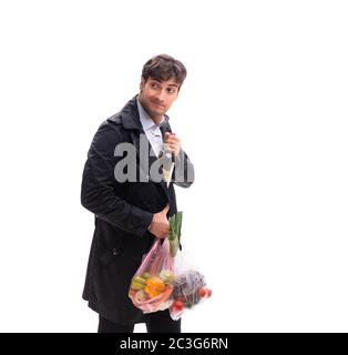 Young handsome man with vegatables in shopping concept Stock Photo