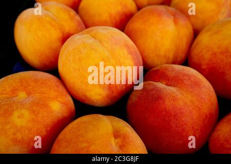 Heap of Fresh Ripe Peaches For Sale on the Market Stock Photo