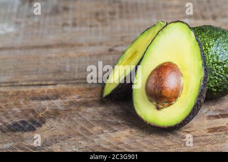 avocado on a dark wood background Stock Photo