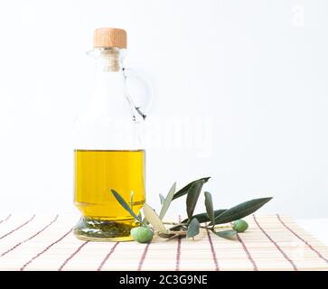 Olive oil glass bottle with an olive tree branch isolated on white ...