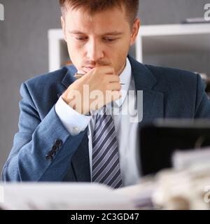 Serious businessman in the office examines documents Stock Photo